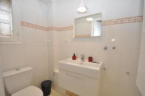 a white bathroom with a toilet and a sink at 9 Rue Buttura in Cannes +7 photos