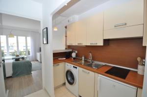 a kitchen with a sink and a washing machine at 9 Rue Buttura in Cannes