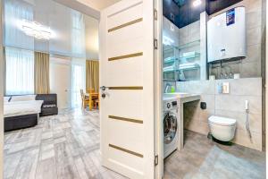 a bathroom with a washer and dryer in a room at Apartment Voskresenska 18 , Парковые Озера in Kyiv +18 photos