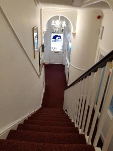 a stairway leading up to a white door at Andorra Guest Accommodation in Brighton & Hove