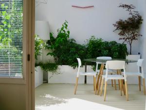 a table and chairs in a room with plants at Apartment with terrace 5 people Bastille by Weekome in Paris