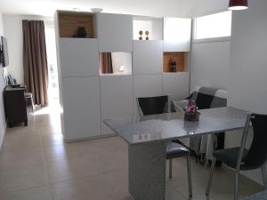 a kitchen with a table and chairs in a room at Pasco 1847 Apartamento5 A in Rosario +3 photos