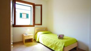 Cama ou camas em um quarto em Residence Il Corallo