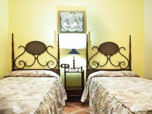 a bedroom with two beds and a lamp at Holiday Home Camino La Candelaria-2 by Interhome in La Orotava