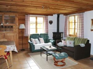 a living room with a couch and a table at Apartment Lärchehus by Interhome in Gstaad