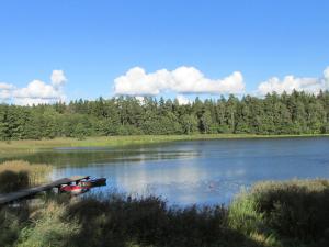a lake with a boat on the side of it at Holiday Home Mielno 2 by Interhome in Mielno