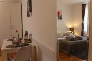 1 dormitorio con cama, mesa y escritorio en Downtown Main Street Studio, en Zadar