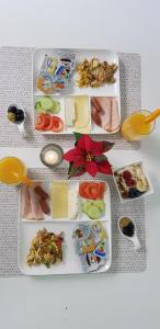 a table with several plates of food on it at Hotel Sansa in Maastricht