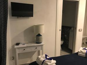 a bedroom with a tv and a table with a lamp at B&B Casa Gaia in Città della Pieve