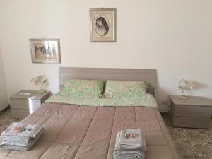 a bedroom with a large bed with two night stands at Casa Pierina in Alghero