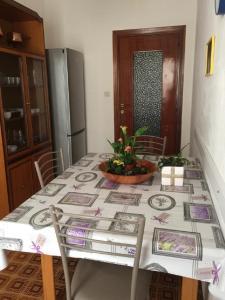 a dining room table with a table cloth on it at Casa Pierina in Alghero