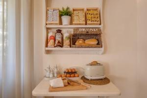 a small kitchen with a refrigerator with food on a counter at Hotel Massimo in Marina di Cecina