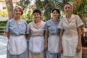a group of four women standing next to each other at Hotel Massimo in Marina di Cecina