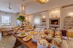 a table with many plates of food on it at Hotel Massimo in Marina di Cecina