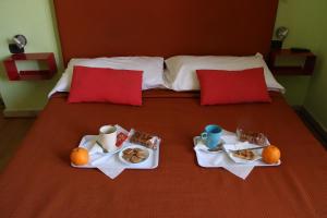 Postel nebo postele na pokoji v ubytování Colosseoinn + 2 fotografie