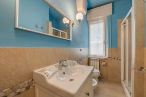 a bathroom with a sink and a toilet at Hotel Massimo in Marina di Cecina
