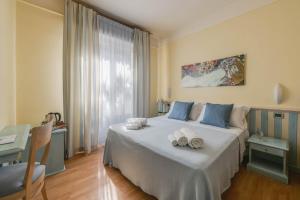 a bedroom with a bed with towels on it at Hotel Massimo in Marina di Cecina