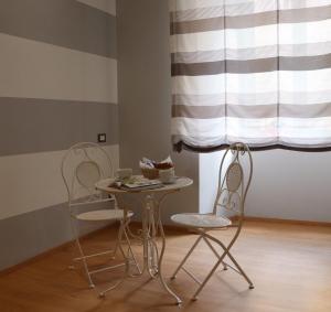 two chairs and a table and a table and chairs at The Center Of Rome B&B in Rome