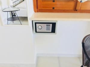 a clock on the wall of a room with a chair at B&B Pizzomunno e Cristalda Rooms in Vieste