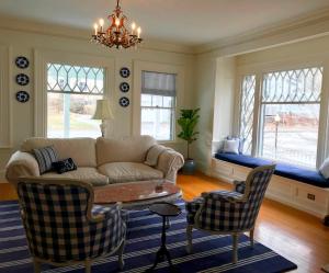 a living room with a couch and a table and chairs at The Belmont Inn in Camden