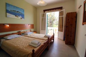 Postel nebo postele na pokoji v ubytování House Dimitri Agios Georgios Pagoi Corfu