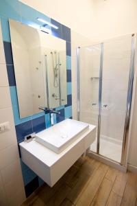 a bathroom with a white sink and a shower at Casa Sorrentina in Sorrento