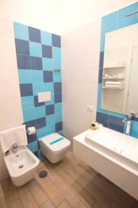 a bathroom with a white toilet and a sink at Casa Sorrentina in Sorrento