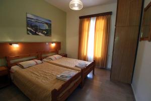 Postel nebo postele na pokoji v ubytování House Dimitri Agios Georgios Pagoi Corfu