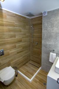 a bathroom with a shower with a toilet and a sink at Kahlua Hotel Apartments in Rhodes Town