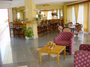 a lobby with chairs and a table and a bar at Palmasol Hotel in Triánta