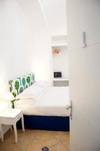 a small bedroom with a bed and a table at Casa Sorrentina in Sorrento