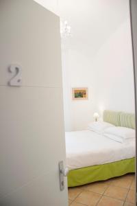 a bedroom with a bed and a door open at Casa Sorrentina in Sorrento