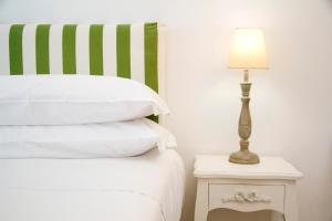 a bed with a lamp on a table next to it at Casa Sorrentina in Sorrento