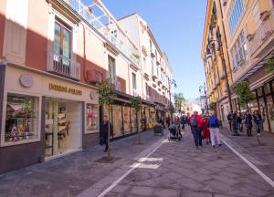 a group of people walking down a street with buildings at Casa Sorrentina in Sorrento