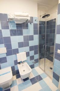 a blue tiled bathroom with a toilet and a shower at Casa Sorrentina in Sorrento