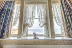 a window with a view of the ocean at Tynemouth Grand Hotel in Tynemouth