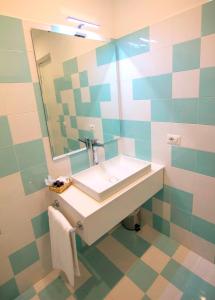 a bathroom with a sink and a mirror at Casa Sorrentina in Sorrento
