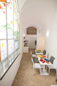 a dining room with a table and chairs at Casa Sorrentina in Sorrento