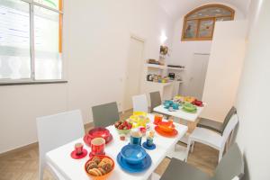 a dining room with a table with food on it at Casa Sorrentina in Sorrento