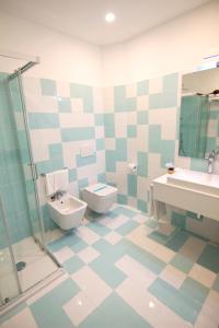 a bathroom with a toilet and a sink at Casa Sorrentina in Sorrento