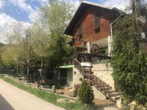 a brick house with stairs leading up to it at Casa Parvu in Lunca Mare