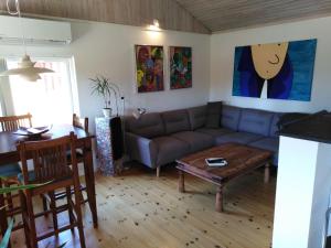a living room with a couch and a table at Feriehus Roskilde fjord in Skibby