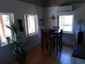a dining room with a table and chairs and windows at Feriehus Roskilde fjord in Skibby +9 photos