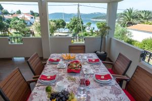 a table with food on it with a view of the water at Villa Kaliope in Brgulje