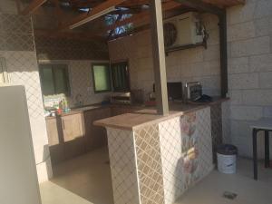 a kitchen with a counter and a microwave at Jericho Waleed's Hostel in Jericho