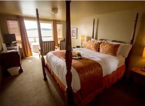 a bedroom with a large bed and a large window at Camano Island Inn in Camano