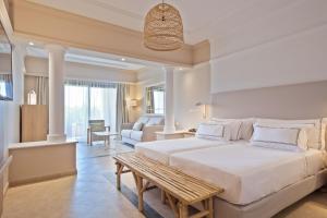 a bedroom with a large bed and a couch at Melia Villaitana in Benidorm