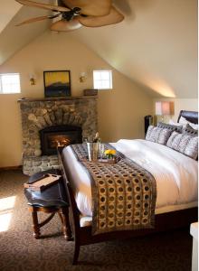 a bedroom with a bed and a stone fireplace at Camano Island Inn in Camano