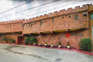 a brick building with a heart painted on it at MOTEL RED LOVE in Belo Horizonte