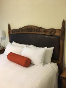 
a bed with a white comforter and pillows at The Eagle Inn in Santa Barbara
